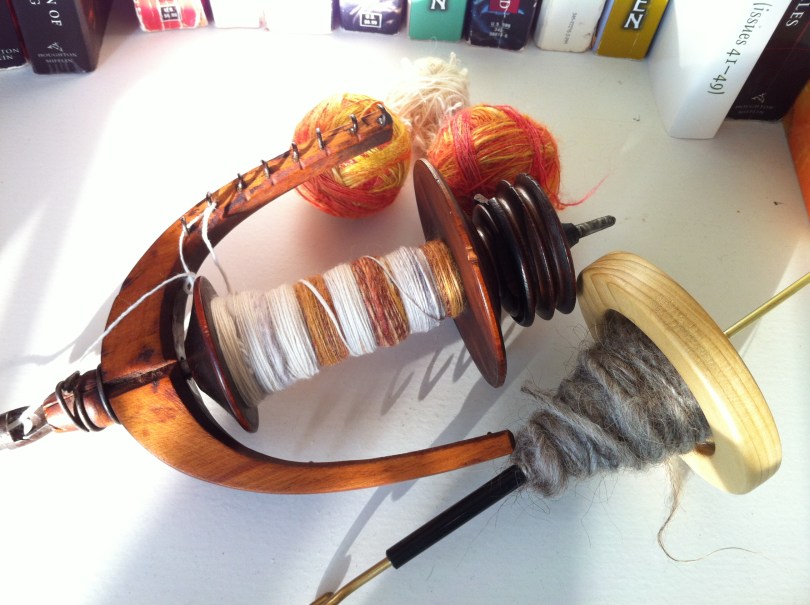 Unfinished odds and ends: Merino on the bobbin, Icelandic on the spindle, balls of silk in the background.